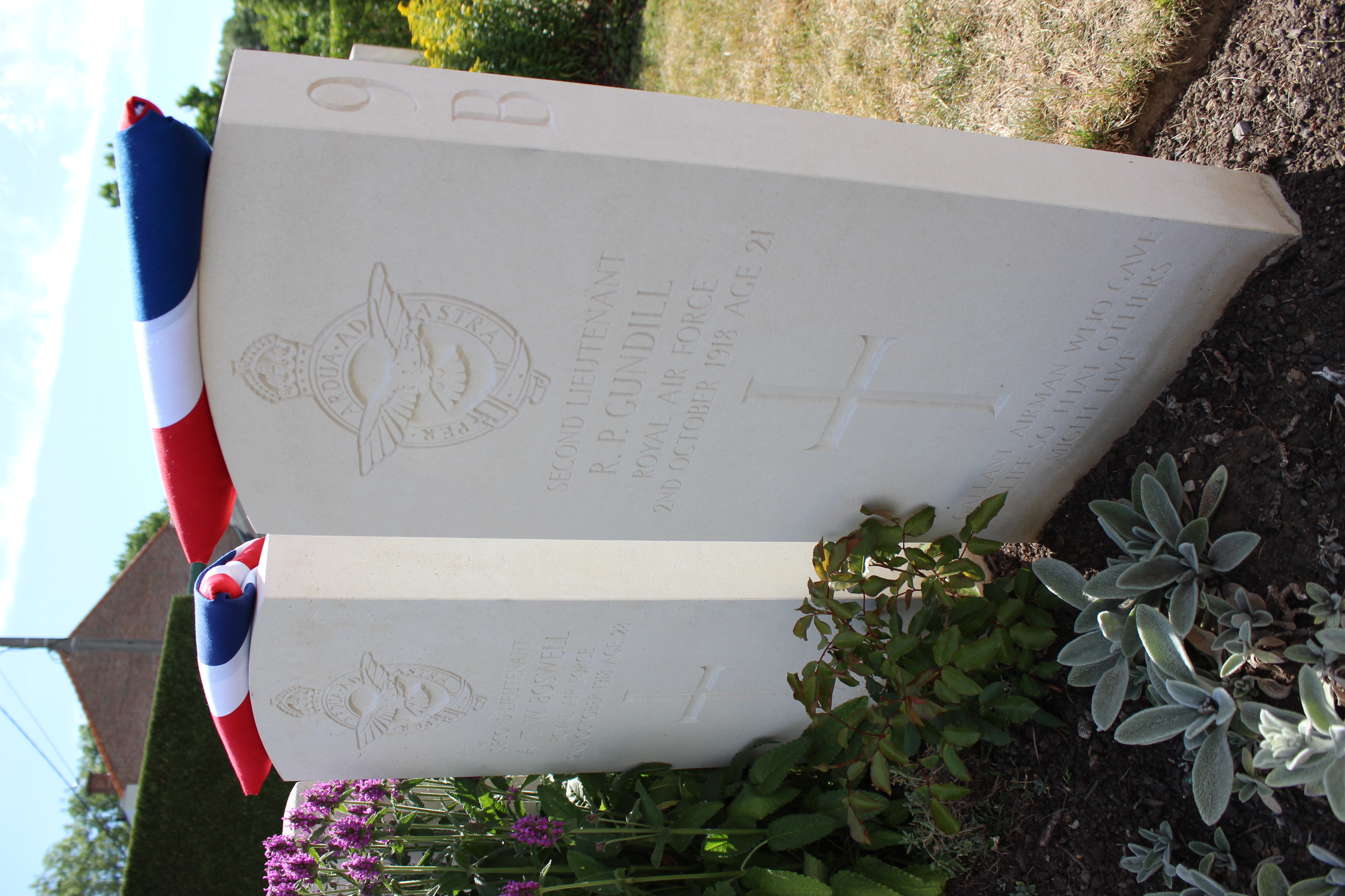 Headstones with flowers and union jack flags.